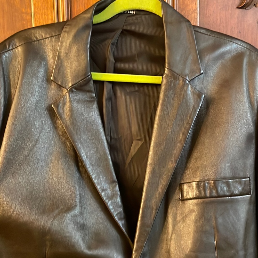This is a brown color leather jacket from Alfani.